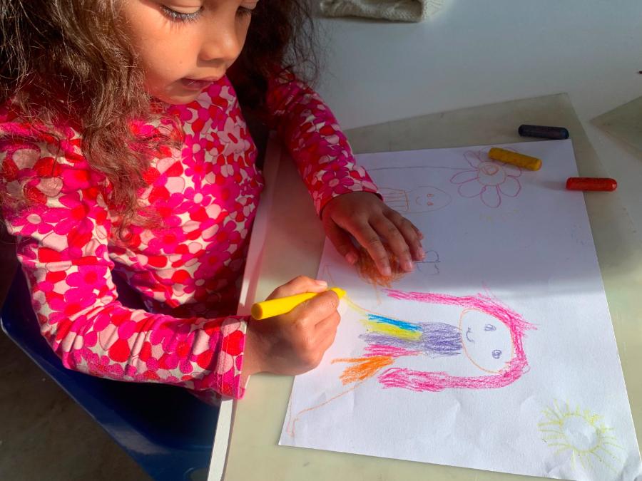 Girl drawing with crayons