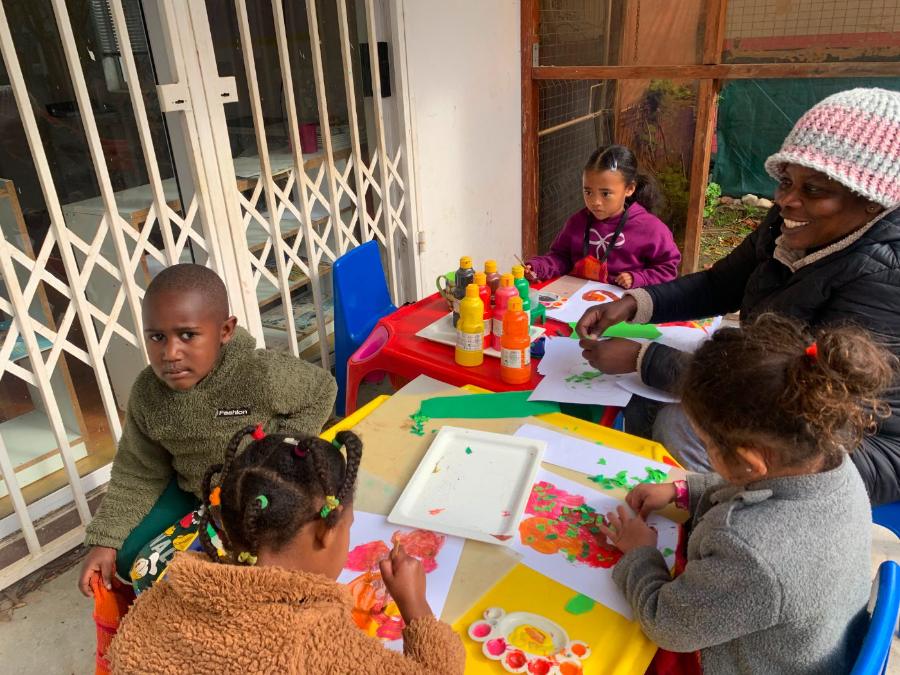 Teacher painting with children