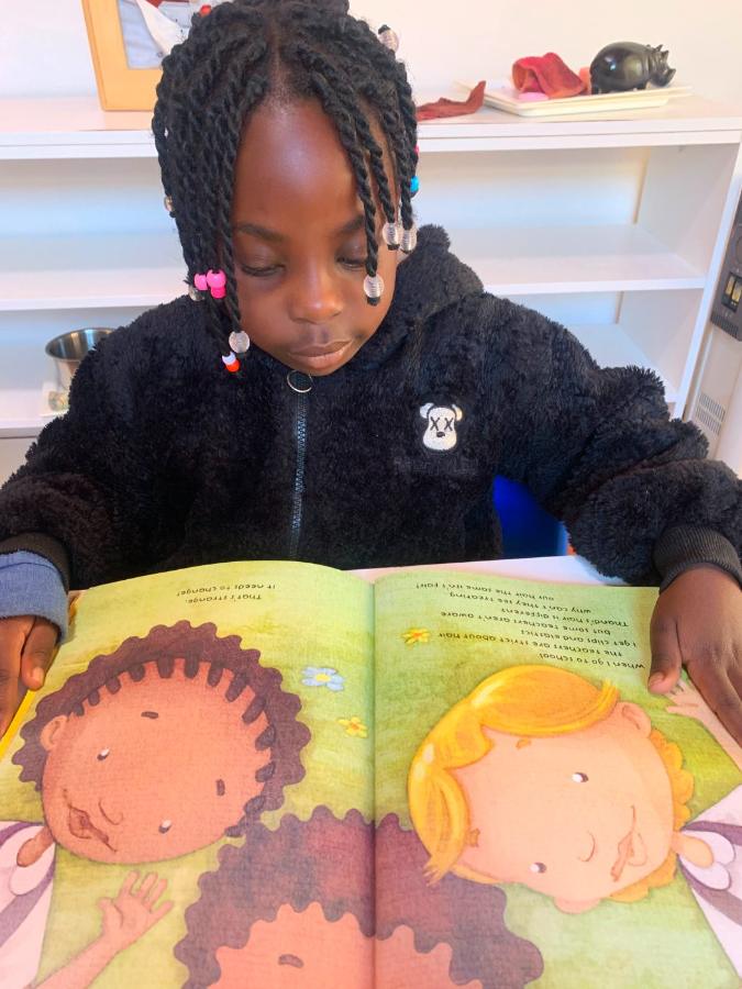 Girl reading a picture book